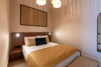 a bedroom with a bed and a chandelier at Ando Living - Santa Catarina House in Porto