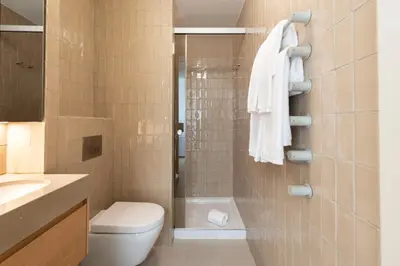 a bathroom with a shower and a toilet and a sink at Ando Living - Santa Catarina House in Porto