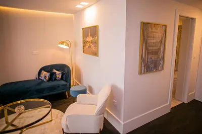 a bedroom with a bed with two pictures on the wall at 262 Boutique Aliados in Porto