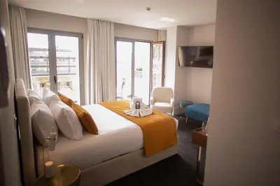 a hotel room with two beds and a piano at 262 Boutique Aliados in Porto