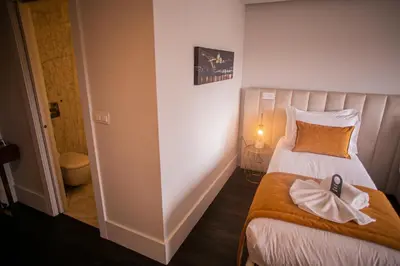 a hotel room with a bed and a sign on the wall at 262 Boutique Aliados in Porto