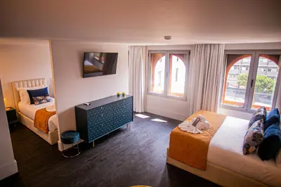 a hotel room with a bed and two chairs at 262 Boutique Aliados in Porto
