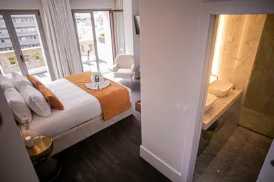 a bathroom with a shower and a toilet and a sink at 262 Boutique Aliados in Porto
